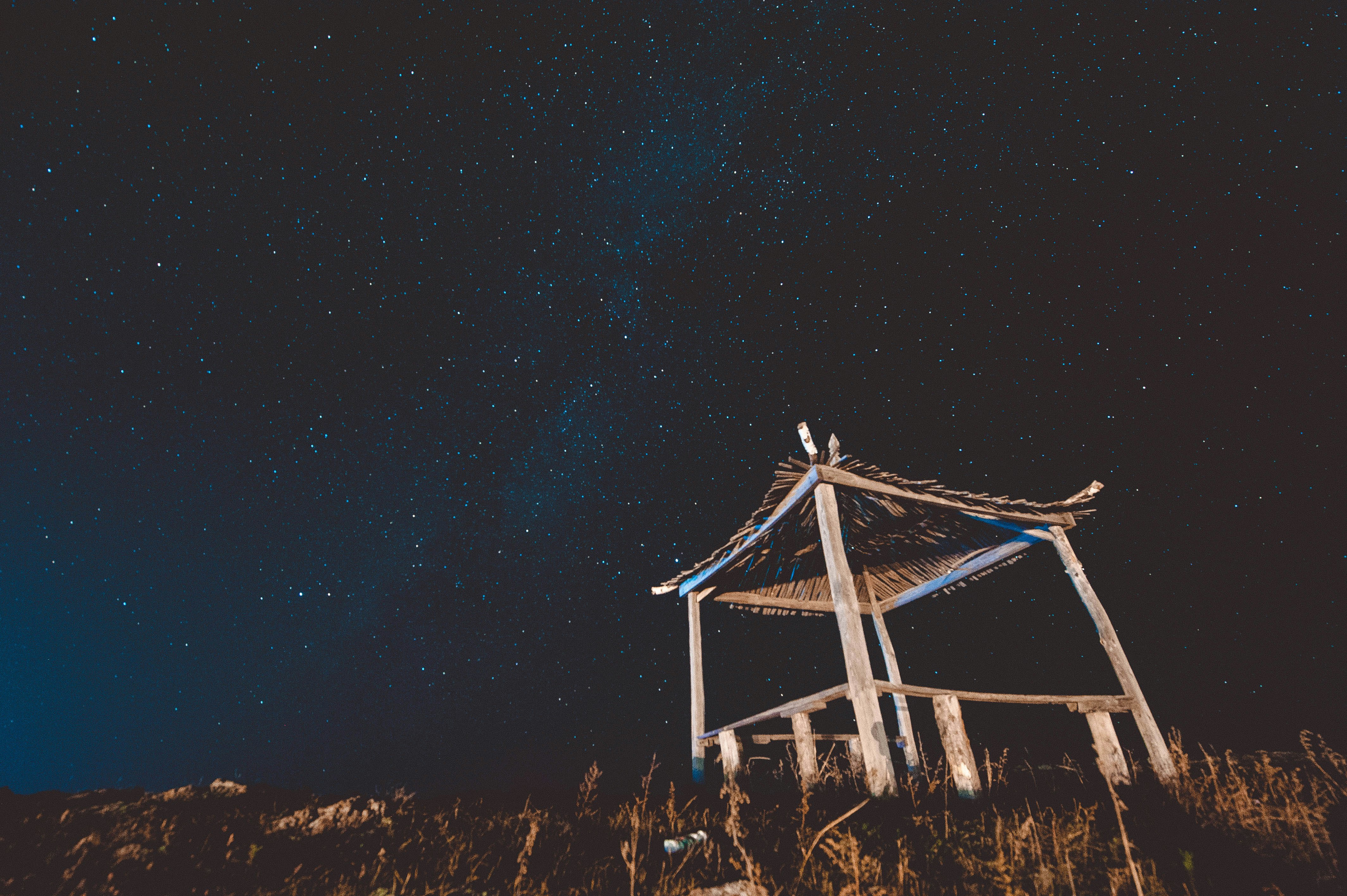 bottom view of wooden hut and starry sky